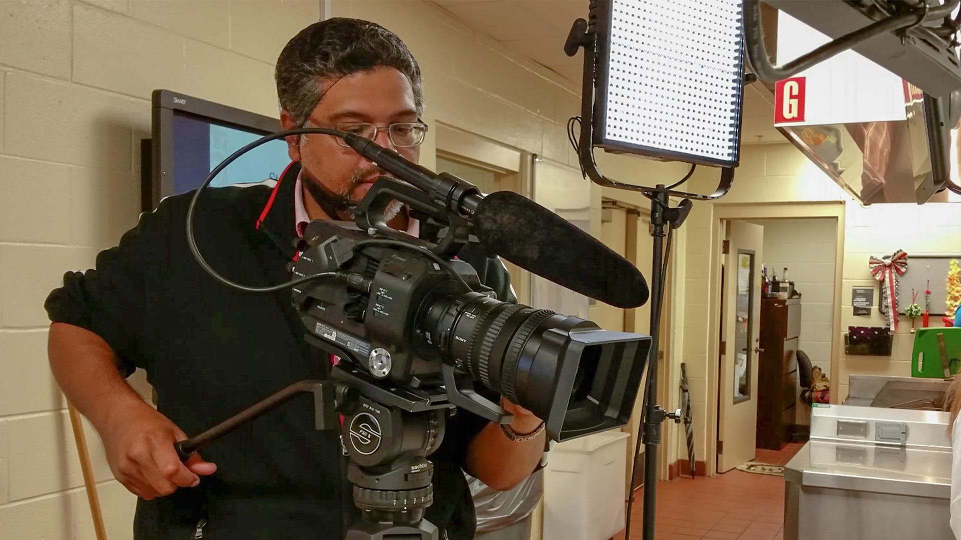 Man operating a TV camera.